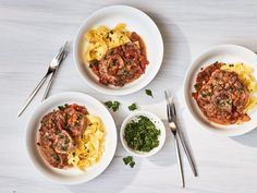 three white bowls filled with pasta and sauce