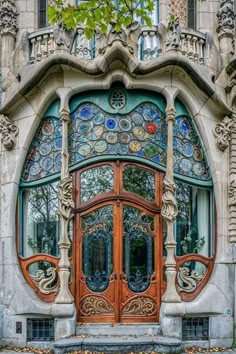 an ornately designed entrance to a building with stained glass windows and doors on each side