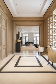 an elegant living room with marble floors and walls