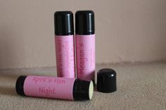 two pink lip bales sitting next to each other on top of a carpeted floor