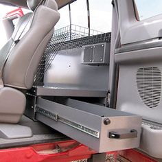 the interior of a vehicle with its door open and seats folded down on it's side