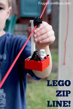 a young boy is playing with legos in the yard and has his hand holding out to