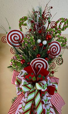 a christmas wreath with candy canes and greenery