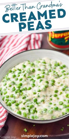 a bowl filled with creamed peas on top of a wooden table