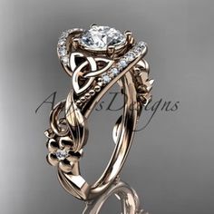 an intricately designed wedding ring set with a center stone surrounded by leaves and vines