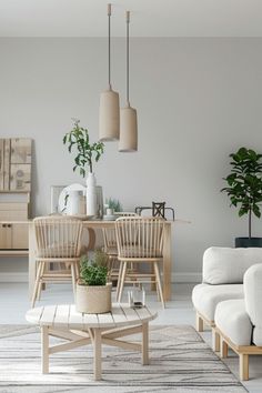 a living room filled with furniture and plants on top of a wooden table in front of a white wall