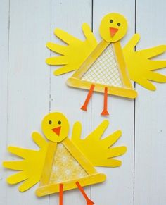 two yellow paper cut outs with birds on them