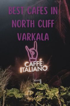 a sign that says best cafe in north cliff, varkala with an image of a hand making the peace sign