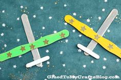 two popsicle shaped snowboards sitting on top of a green surface with white stars