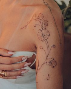 a woman's arm with flowers on it