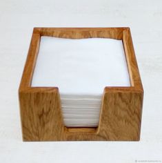 a wooden holder with napkins in it