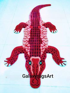 a red and white alligator rug sitting on top of a tile floor