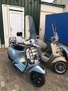 two motor scooters parked next to each other