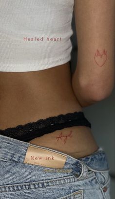 a woman's stomach with the word new ink on her left side, in red ink