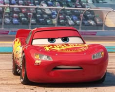 the character cars from disney pixars is driving on the track