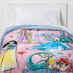 the little mermaids are sleeping in their bed comforter and pillowcase, which is also on display