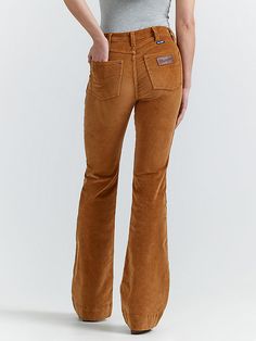 Your favorite flare is back, but now in the perfect texture for the season ahead. Our Women’s Wrangler Retro® Bailey High Rise Corduroy Trouser Jean comes with all the same iconic details, including our signature five-pocket styling, the “W” stitching, and a logo patch. That ultra-soft corduroy is crafted from a cozy cotton blend with just the perfect amount of stretch. Best of all, these trousers feature a flattering high-rise silhouette that hugs you in all the right places. Wrangler Corduroy Pants, Trouser Jeans Outfit Western, Corduroy Flare Pants Outfit, Trouser Jeans Outfit, Casual Womens Shoes, Corduroy Pants Outfit, Western Pants, Corduroy Flare Pants, Flattering Outfits