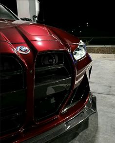 the front end of a red sports car