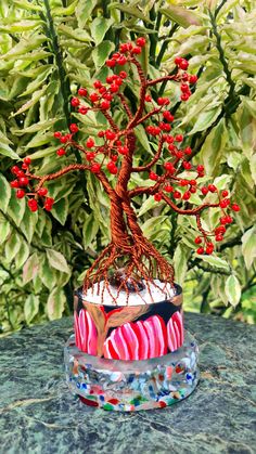 a cake decorated with red berries and a tree