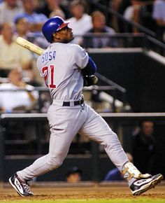 a baseball player holding a bat on top of a field in front of a crowd