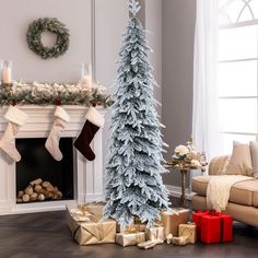 a decorated christmas tree in front of a fireplace