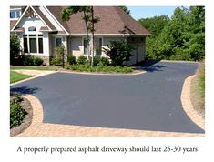 an asphalt driveway that has been cleaned and sealed