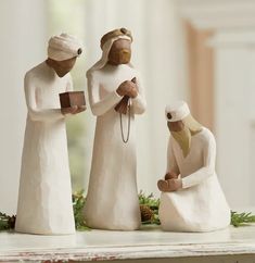 three figurines sitting on top of a table