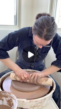 a woman is making a pot on a potter's wheel