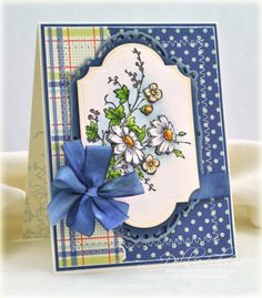 a blue and white card with flowers on it