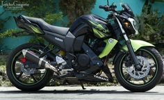 a green and black motorcycle parked on the street