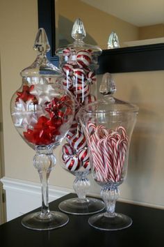 a large glass bowl filled with candy canes on top of a counter