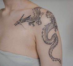 a woman with a dragon tattoo on her left shoulder and right arm is shown in black ink