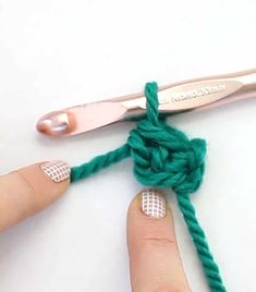 someone is crocheting the knot together with scissors