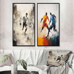 two paintings depicting soccer players are hanging on the wall above a couch in a living room