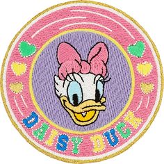 a pink and yellow patch with an image of a cartoon duck wearing a bow on it's head