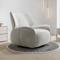 a white chair sitting on top of a wooden floor next to a dresser and lamp