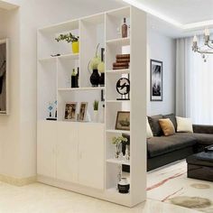 a living room filled with furniture and a flat screen tv on top of a wall