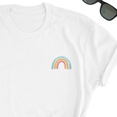 Rainbow Shirt, Cute Rainbow T-Shirt, Rainbow Cute shirt, Happiness Cute T-shirt, Summer Lover Tee, Optimism Lover Clothing, Rainbow Cute Top, UNISEX This t-shirt feels soft and lightweight, with the right amount of stretch. It's comfortable and flattering for both men and women. * 100% cotton (heather colors contain polyester) * Fabric weight: 5 oz * Shoulder-to-shoulder taping * Side-seamed Time for Delivery: * Processing & production time is 1-6 business days (usually 2-3 days). * U.S. Shi Pre-shrunk Cotton Rainbow T-shirt, Rainbow Short Sleeve Tops With Graphic Print, Fun Rainbow Print Short Sleeve Top, Rainbow Graphic Print Short Sleeve Top, Casual Rainbow Print Short Sleeve T-shirt, Trendy Cotton T-shirt With Rainbow Print, Rainbow Print Cotton Short Sleeve Tops, Casual Short Sleeve T-shirt With Rainbow Print, Cute Multicolor T-shirt With Rainbow Print