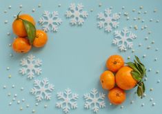 oranges and snowflakes arranged in the shape of a circle on a blue background