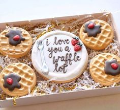 four waffles in a box with writing on them