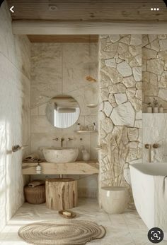 a bathroom with stone walls and flooring is shown in this image, there are two sinks on either side of the bathtub