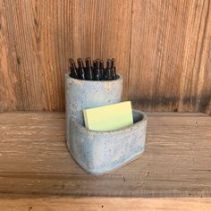 a pen holder with several pens in it