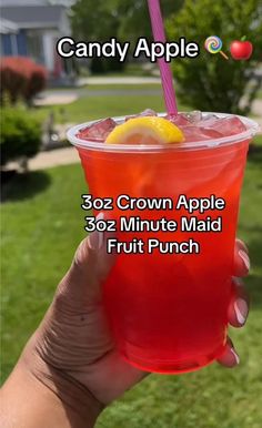 a person holding up a red drink in front of a green lawn with the words, candy apple 32oz crown apple 30 minute maid fruit punch