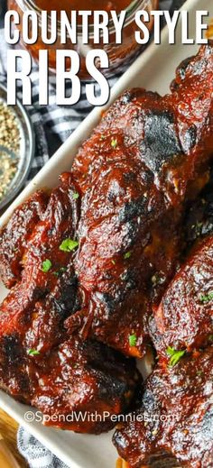 ribs covered in bbq sauce and garnished with parsley on the side