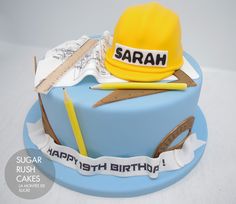 a birthday cake with a yellow hat and some scissors