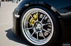 the front wheel of a black sports car