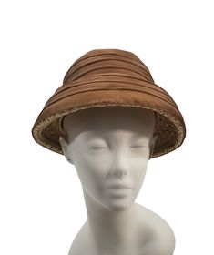 Vintage Natural Straw Raffia Basket Hat with Brown Band by Helma's Studio, Size 6 3/4 Natural straw raffia basket hat with a brown sheer pleated band that covers all but the very top of the hat. Two small velvet bows on the back, each one is a slightly different brown color. Size: 6 3/4 - measured with a hat measuring tool Label: Helma's Studio Lakewood, Ohio Condition Several small holes in the band. Vintage is anything over 20 years old, I try my best to disclose any flaws that are visible to the eye, such as stains, discolorations, damage and normal wear and tear. All Sales are Final. Item will ship within 3 to 5 business days Domestic Shipping via USPS  International Shipping via USPS International First Class ~~Thank you for Shopping with Kris's Vintage Clothing~~ Basket Hat, Lakewood Ohio, Raffia Basket, Cloche Hats, Velvet Bows, Knee Length Coat, Silver Cloud, Cloche Hat, Vintage Vanity