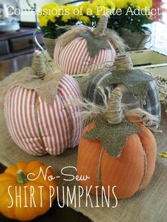 three decorative pumpkins sitting on top of a table