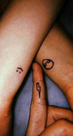 two people with matching tattoos on their arms