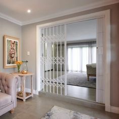 a living room filled with furniture and a large glass door